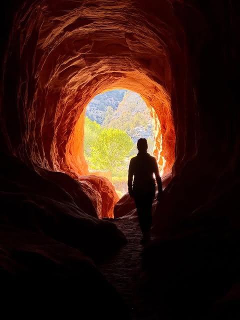 A visitor silhouetted inside Belly of the Dragon